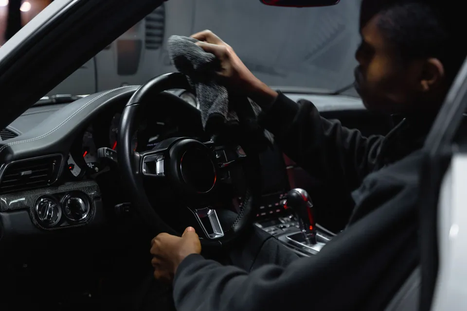 Detailer wiping a steering wheel